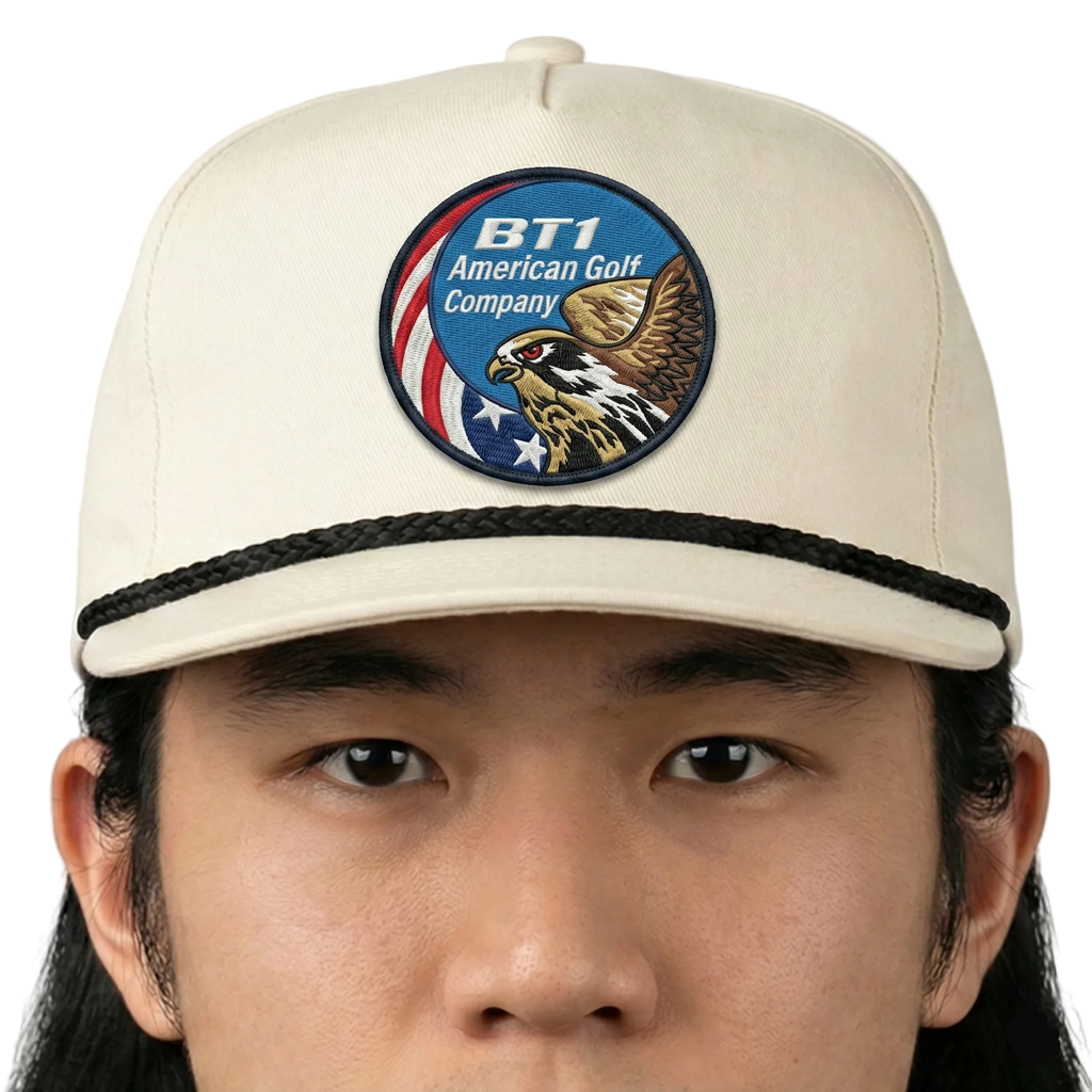 Beige cap with a logo featuring an eagle and text on a white background