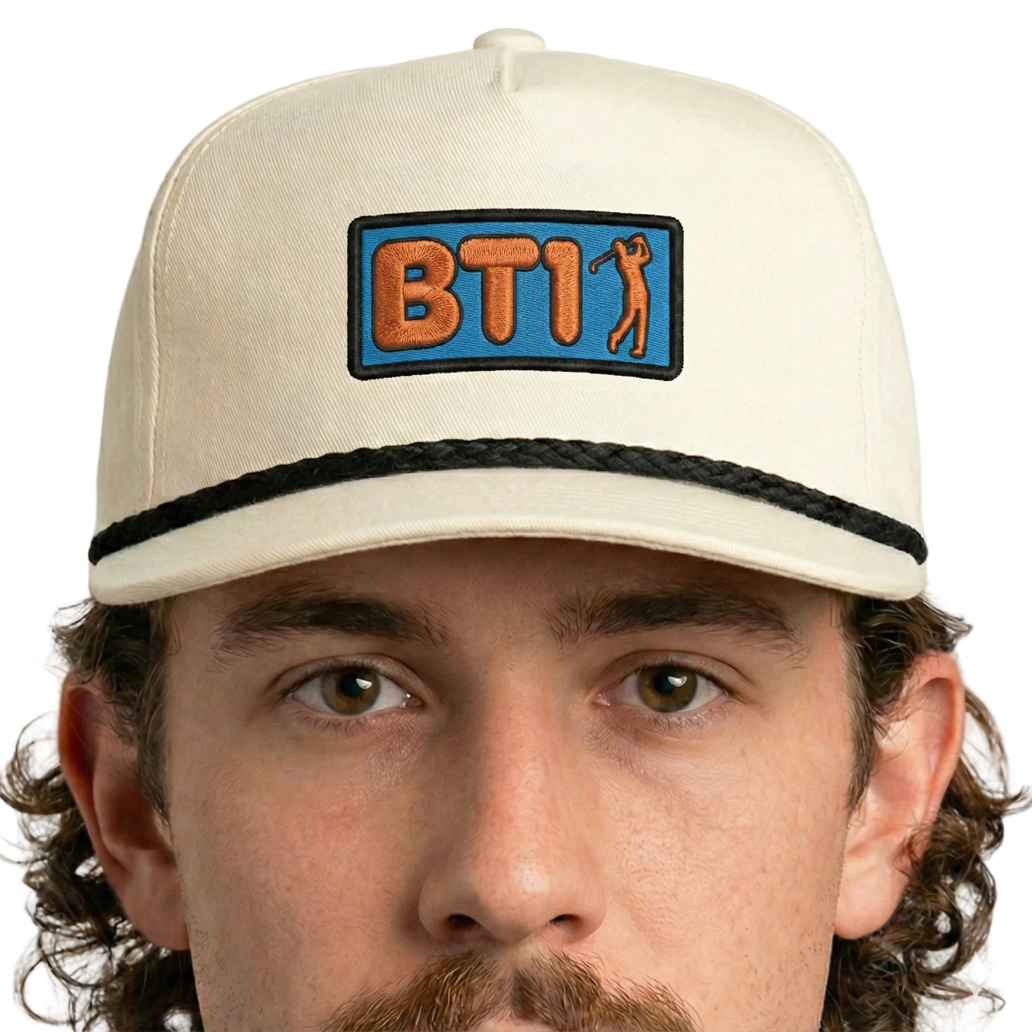 Man wearing a beige cap with a BT1 logo on a white background
