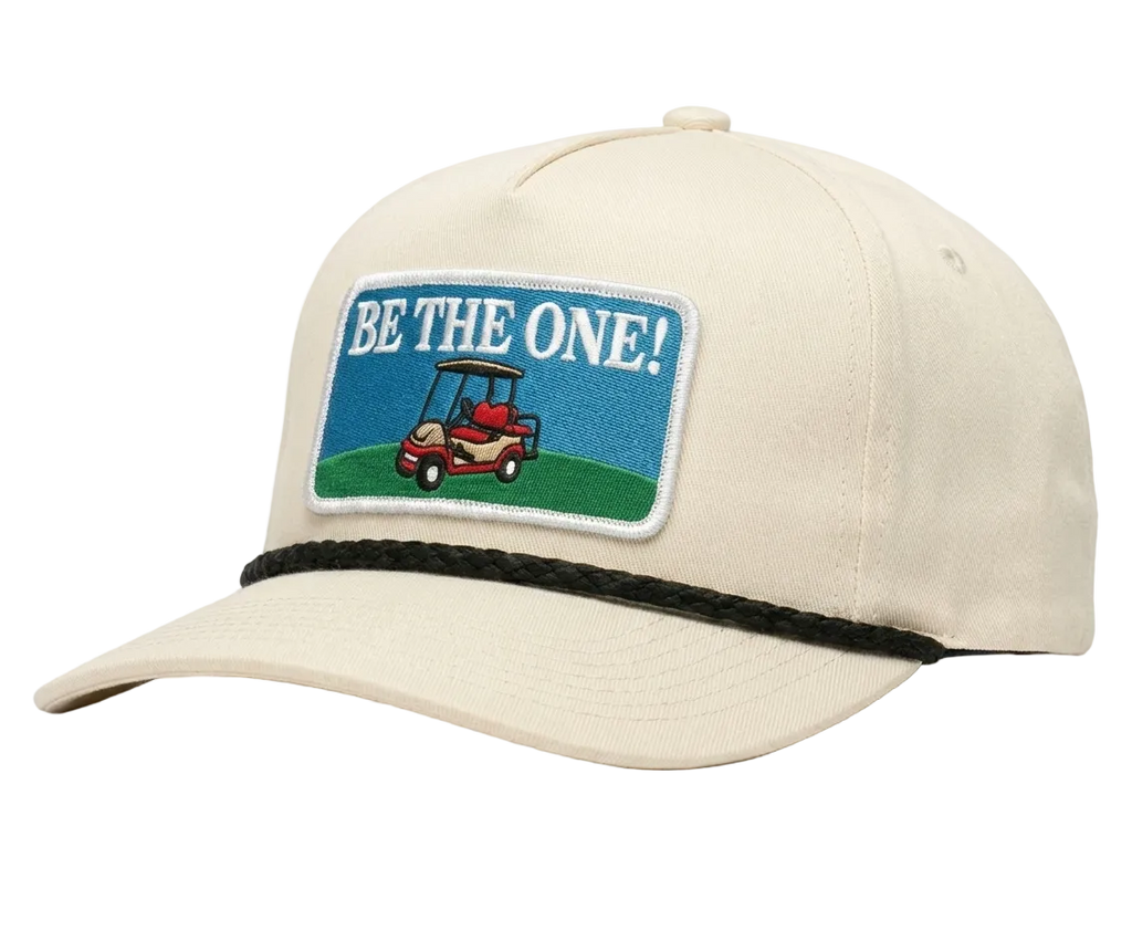 Beige cap with a patch featuring a golf cart and 'Be the One!' text on a white background